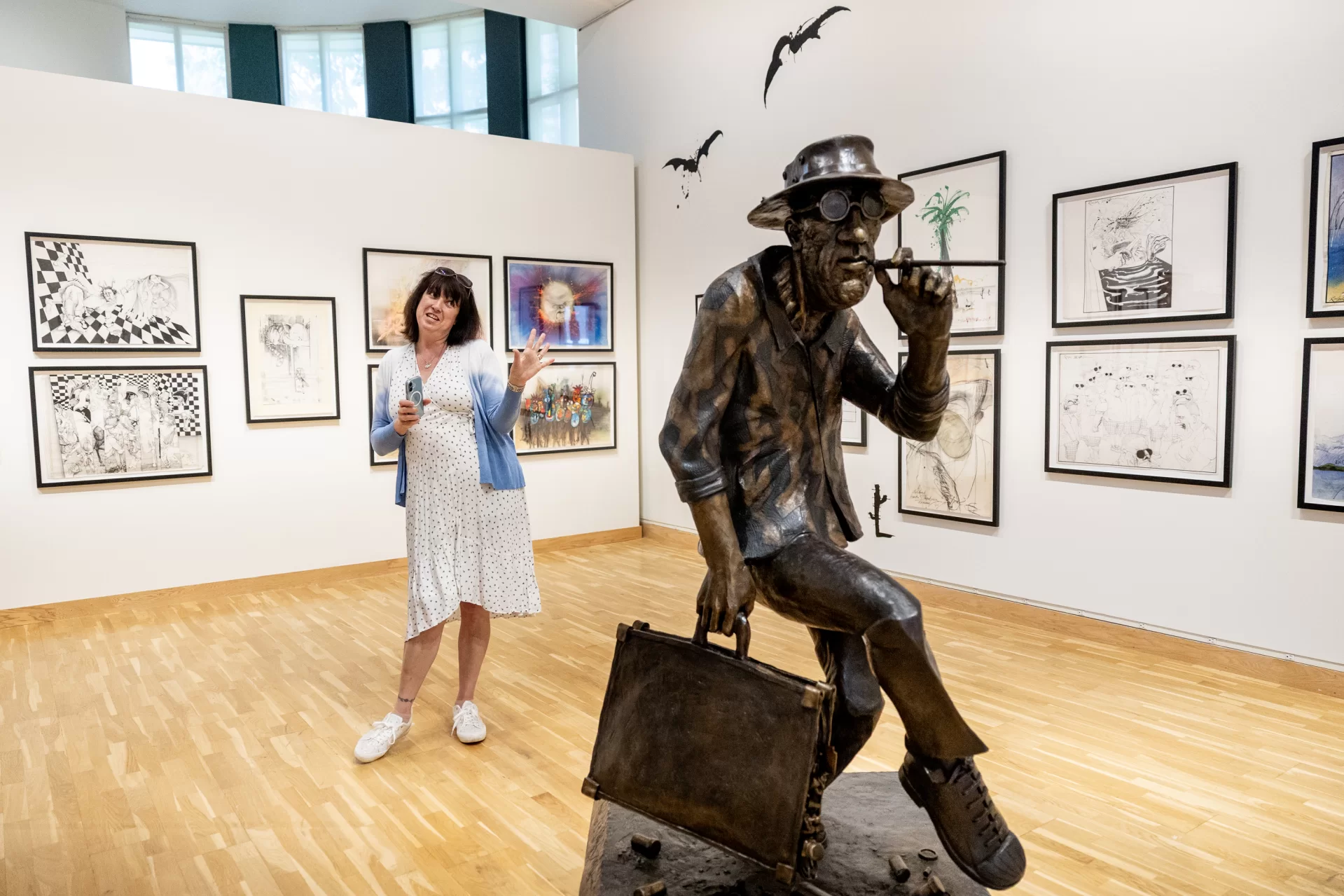 Sadie Williams, Ralph Steadman’s daughter and the managing director of the Ralph Steadman Art Collection, circulates on in the main gallery where an exhibition of her father’s work, “Ralph Steadman: And Another Thing,” opens tomorrow, June 6, 2025, and runs through Oct. 11, 2025, in the Bates Museum of Art. This extensive traveling exhibition spans over 60 years of Ralph Steadman’s influential and lauded career, and features more than 140 original artworks and ephemera, including sketchbooks, handwritten notes, and personal photographs. Visitors to the exhibition will encounter familiar favorites, like the artist’s illustrations for literary classics such as Lewis Carroll’s Alice in Wonderland and Robert Louis Stevenson’s Treasure Island, as well as works for activist causes, branding iconography, and even a life-sized bronze sculpture.