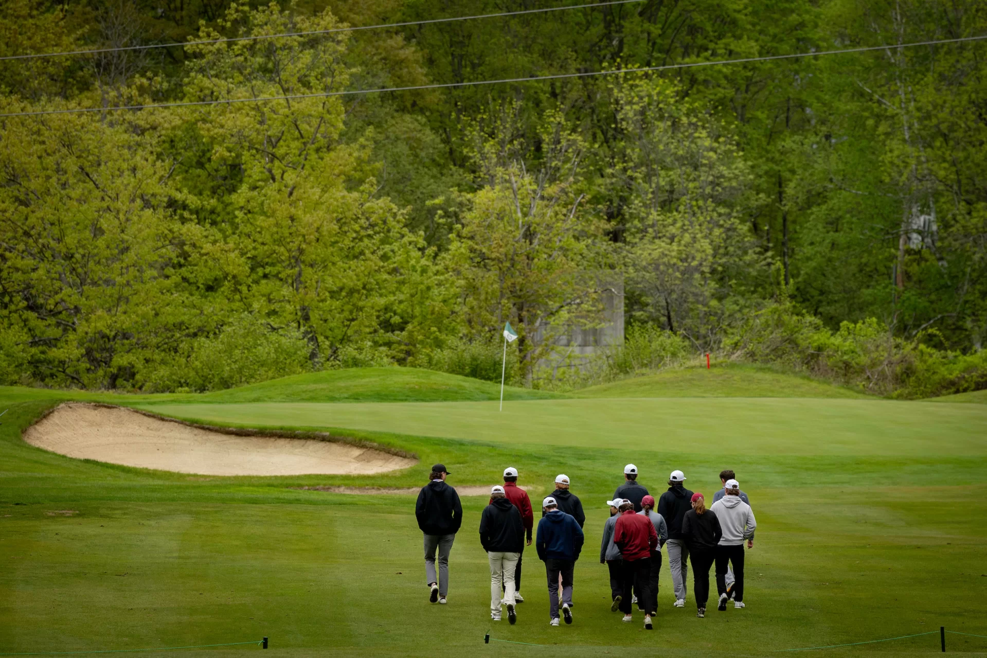 golfers walking onto green