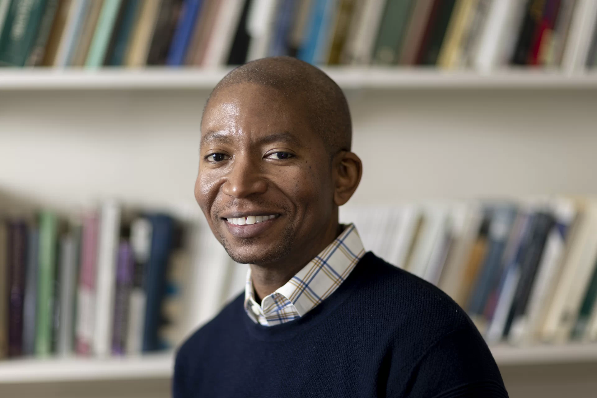 Asistant Professor of English Myronn Hardy poses for a portrait in his Hathon Hall office (Room 308), and meets with his thesis student, Alexander Tan ’23 of Hong Kong.