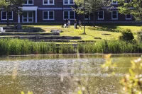 Campus scenery captured on July 24, 2025. Admission tour guide Abdullah Alzamili ‘27 of Lewiston, Maine, leads a group during a campus tour on July 24, 2025. (Theophil Syslo | Bates College)