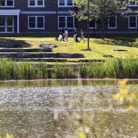Campus scenery captured on July 24, 2025. Admission tour guide Abdullah Alzamili ‘27 of Lewiston, Maine, leads a group during a campus tour on July 24, 2025. (Theophil Syslo | Bates College)
