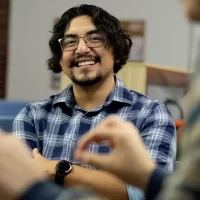 Misa Beltran-Guzman mbeltranguzman@bates.edu Director of First-Generation Programs Student Center for Belonging and Community Misa poses for portraits in his SCBC office and entry, and then interacts with colleagues and students. The session between 4-6 p.m. on Mondays is called “Snack and Chat.” Cooking in kitchen s Bianca Vega, Kessler Scholars program coordinator Sadie New, admission counselor (white blouse) Wearing a Bates hat between Sadie and Misa is Alina Kunakbayeva ’27 of Kazakhstan. Seated with Misa, from left are Alessandra Williams ’29, Kitana James ’29, and Lucy Meeker ’29.