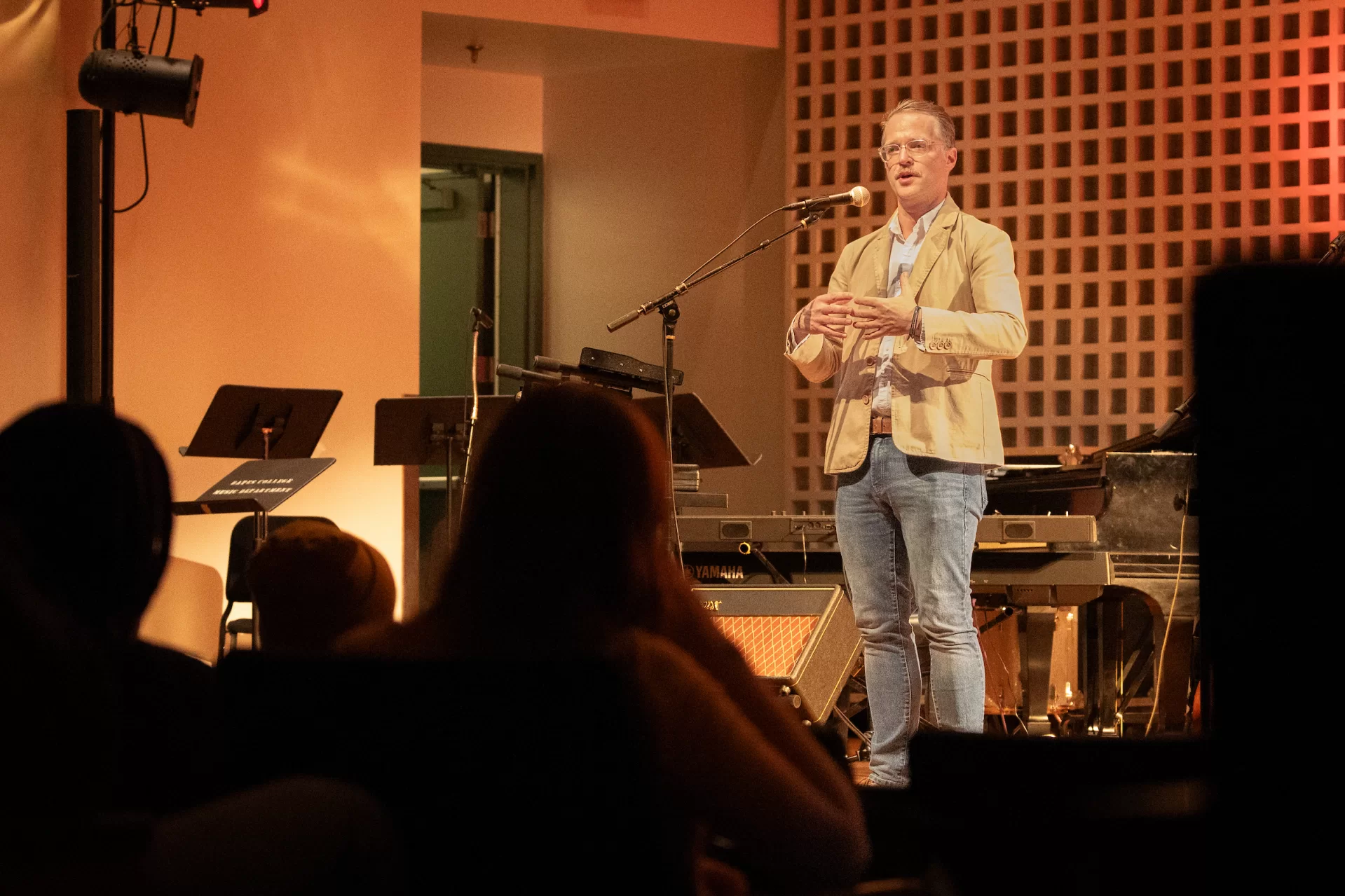 Stuart Gurley, who manages both Olin Arts and the applied music program at Bates, welcomes the audience during the Oct. 25 Fitter Happier performance. Gurley brought together Bates students to play with the Radiohead tribute band. (Sammy Weidenthal ’27 for Bates College)