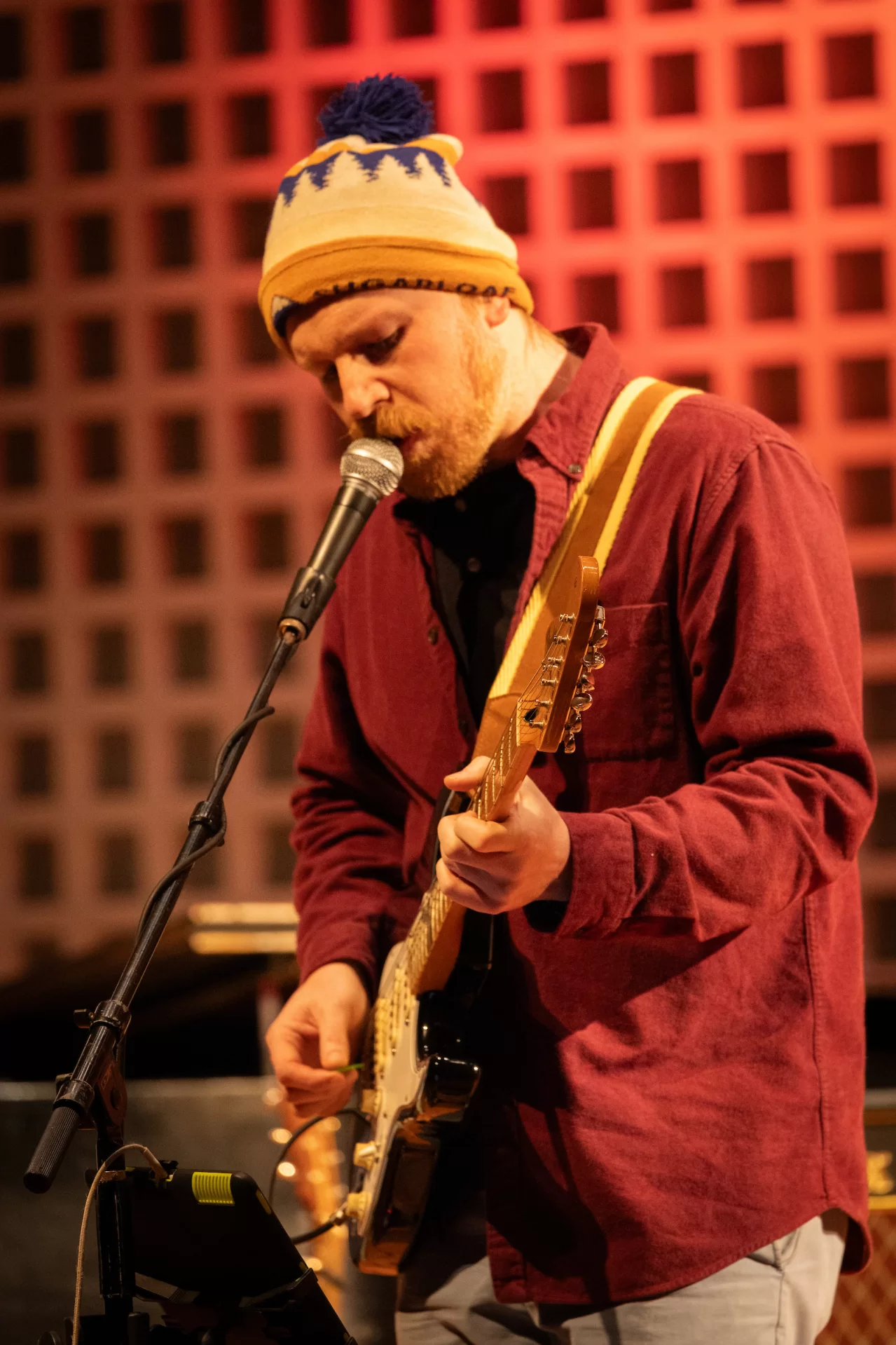 Jeff Beam, the lead singer of Fitter Happier, at the microphone during a concert by the Portland-based Radiohead tribute band at Olin Arts Center Oct. 25. (Sammy Weidenthal ’27 for Bates College)