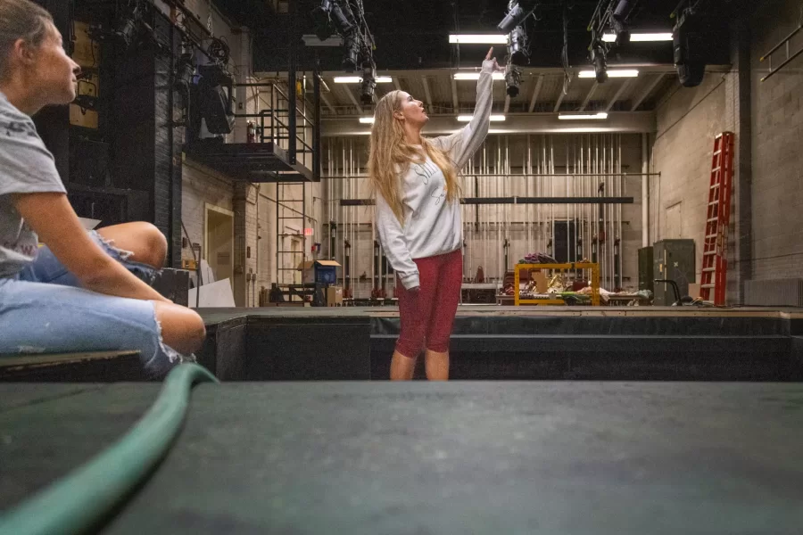 Grace LaFountain '26, knee deep in the shallow pool on the stage at Schaeffer Theatre, the main set for Metamorphoses.  
Sammy Weidenthal '27 for Bates College