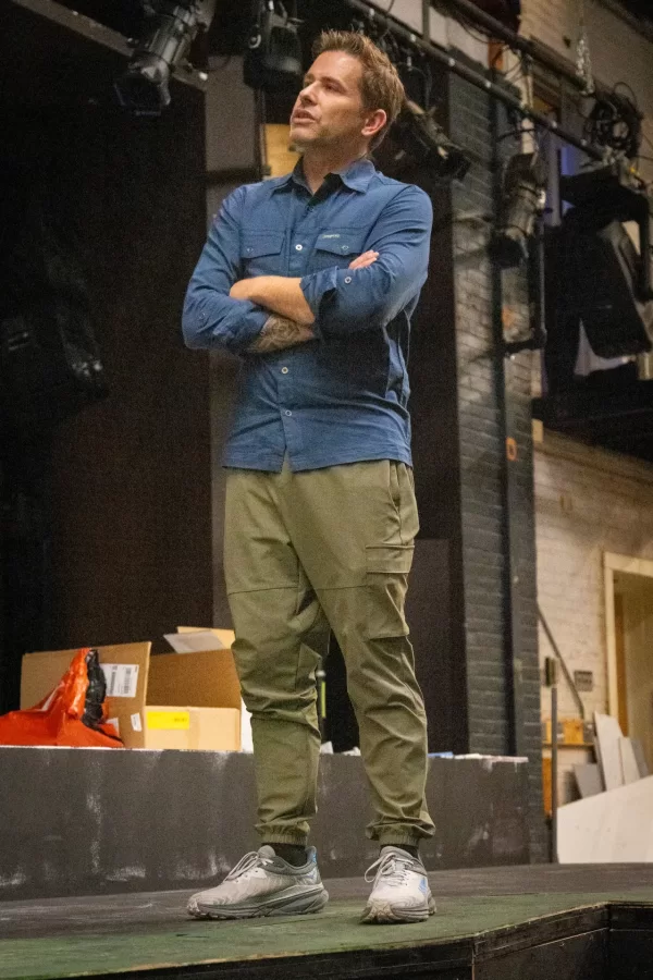 Associate Professor of Theater Courtney Smith on stage at the Schaeffer Theatre during the first run through of filling the water feature that served as the main set for the fall play, Metamorphoses by Mary Zimmerman, directed by Sally Wood, visiting lecturer.  (Sammy Weidenthal ’27 for Bates College)