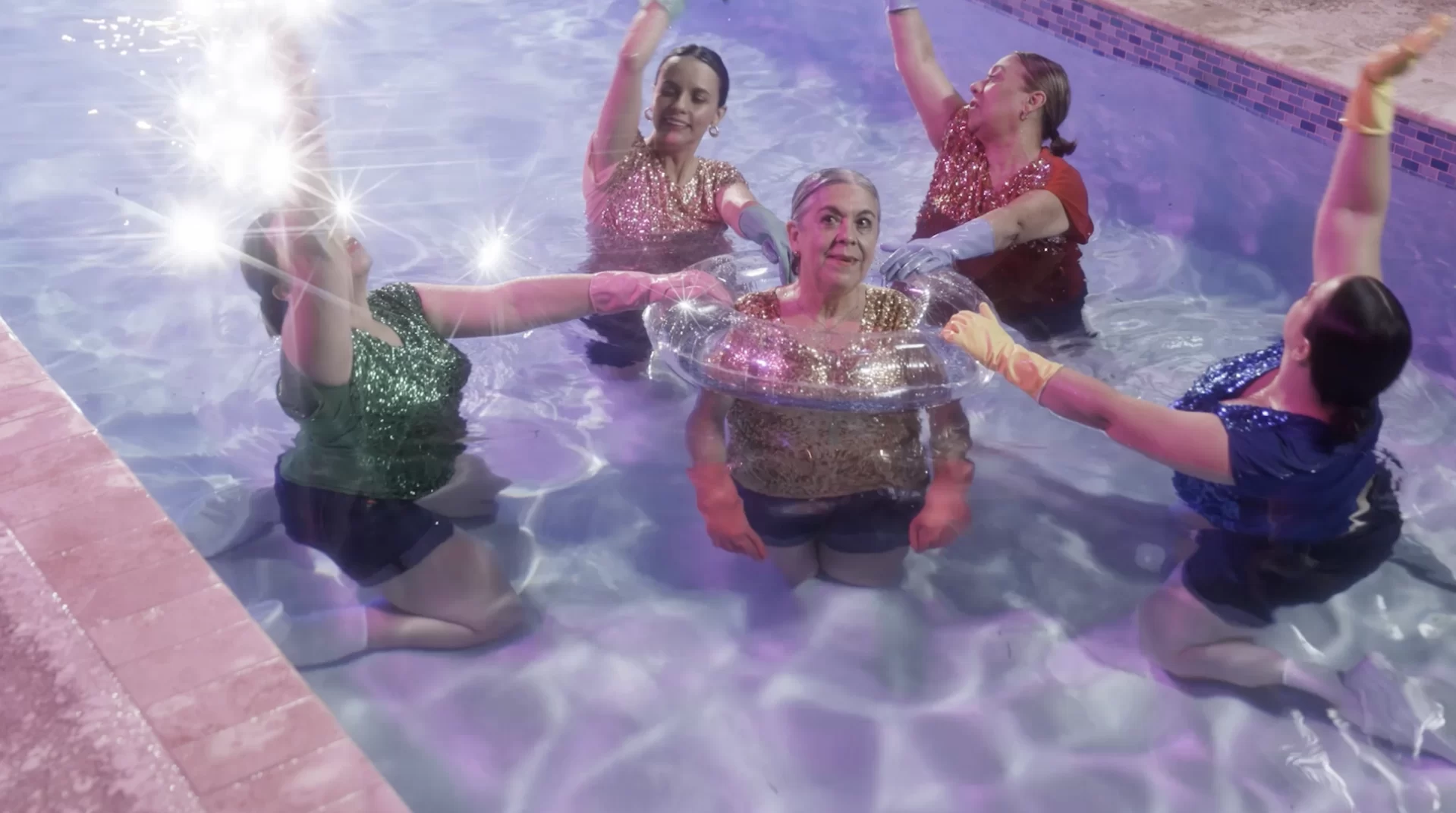 five women in swimming pool; still from film