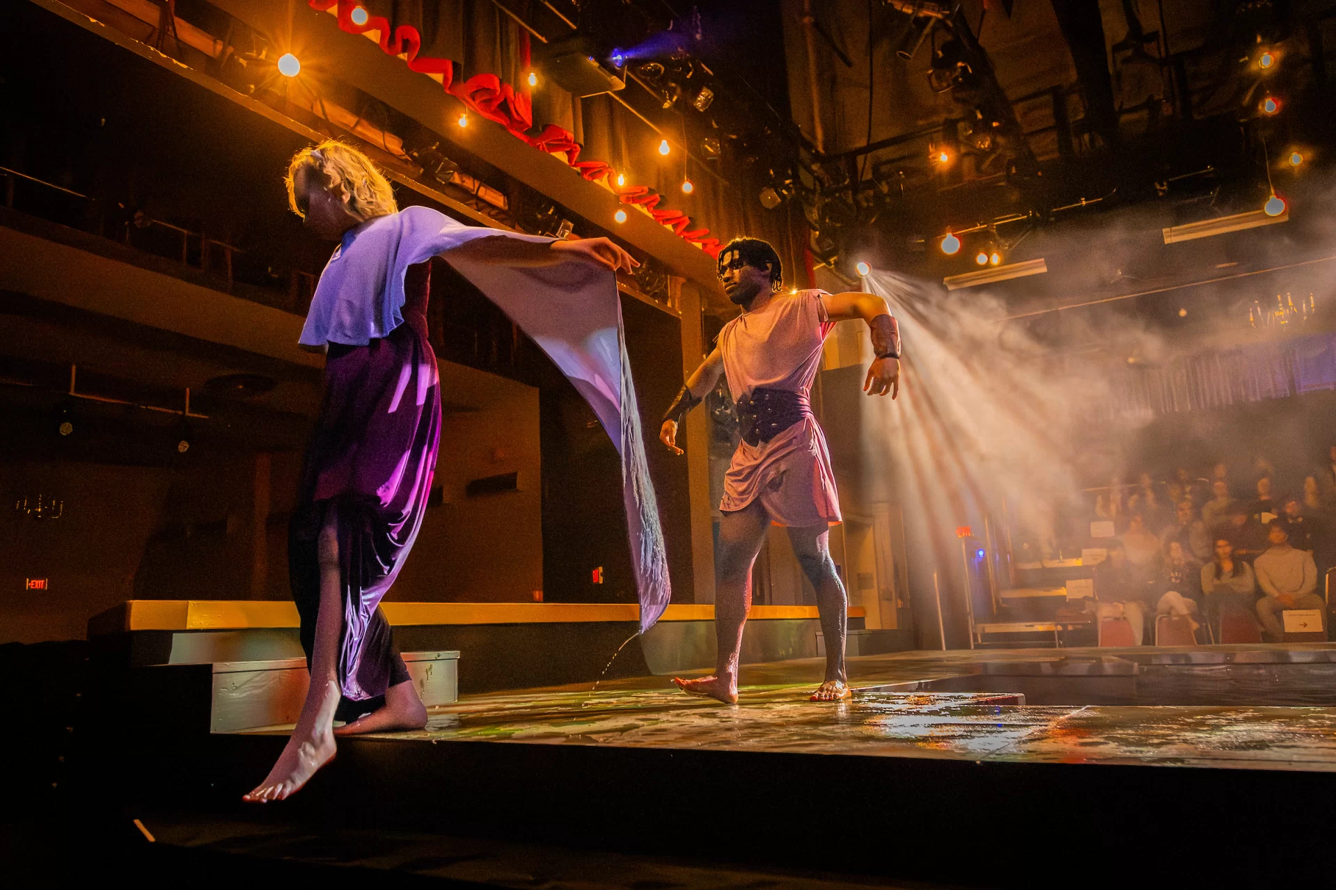 Eirene Furr ’28 of Washington DC, in the role of Alcyone, leaves the stage, after being reunited with her lost husband, King Ceyx, played by Mohamed (Mo) Al-jabry ’28 of Shinyanga, Tanzania. (Sammy Weidenthal ’27 for Bates College)