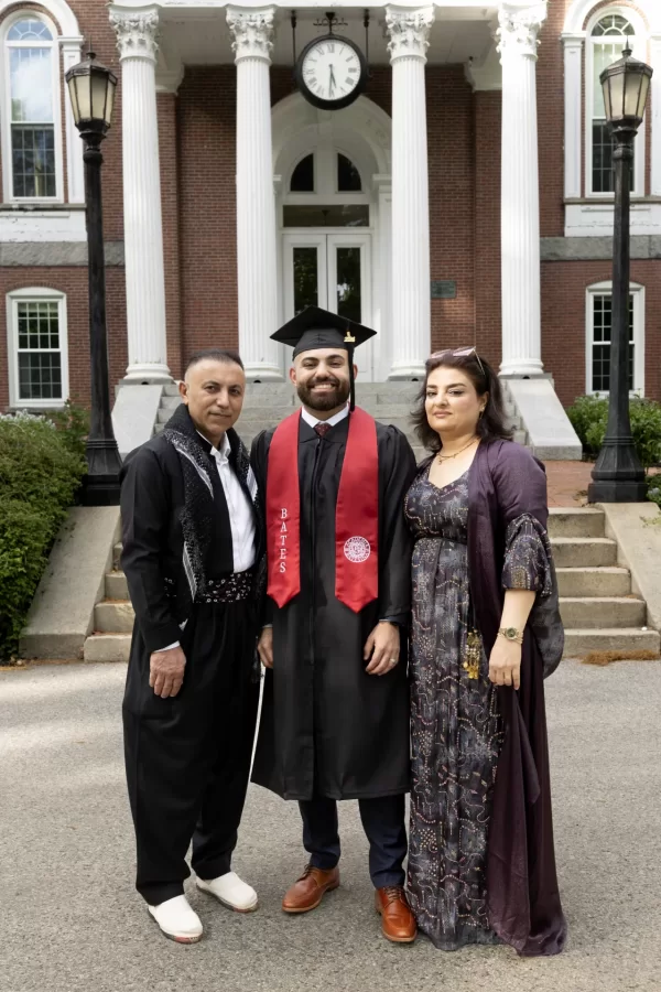 Shwani poses at graduation with his parens. 