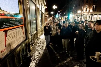 On a chilly night in December, students from Associate Professor of Theater Courtney Smith’s Introduction to Digital Media course presented their final project on Lisbon Street, the heart of Lewiston's historic downtown, and the subject of this interdiscliplinary course (cross listed between theater and digital and computational studies). For their work in this community engaged learning experience, they explored resources that included the Muskie Archives on campus and the Androscoggin Historical Society, to create a multimedia portrait of Lisbon Street, dating back to the days of electric trolley cars. In attendance at the big reveal included Professor Emeritus Doug Hodgkin, Lewiston Mayor Carl Sheline, and Darby Ray, who collaborated with Smith. (Phyllis Graber Jensen/Bates College)