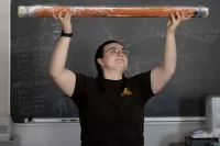 All the way from Greenland, Arctic soil samples give Bates professor, students a glimpse into ancient climate conditions

Hadley Blodgett ’26 of Buckfield, Maine, spends a lot of time thinking about just that — time.

In a laboratory in Carnegie Science Hall, as she conducts research for her senior thesis, Blodgett gazes over 7,000 years of history condensed into a sediment sample extracted from a lake in northern Greenland. As a double major in earth and climate sciences and music, with a minor in religious studies, Blodgett enjoys reflecting on the way that time has constructed and altered her fields of study. Sometimes, when the immensity of the sediment sample’s past hits her, she thinks, “How am I holding this?”
“To think about the scale of what's in front of me is just kind of crazy,” Blodgett says.
How exactly did sediment buried deep beneath Arctic waters find its way to the surface, then to Bates? The story crosses oceans and icebergs, tundras and deserts, but connects to  Bates through Blodgett’s thesis advisor, Associate Professor of Earth and Climate Sciences Nick Balascio.

As a paleoclimatologist, Balascio studies how Earth’s climate system has changed across millennia, primarily through analyzing lake sediment cores, which are layers of mud, dirt, and organic material extracted from the bottom of lakes in long tubes.

“Those lakes are natural history books that record what's going on around the watershed of the lake as well as within the lake itself,” Balascio says.