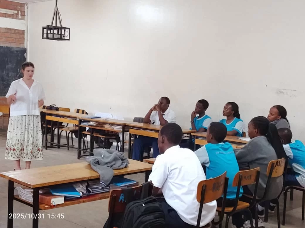A woman teaches a group of students in a classroom