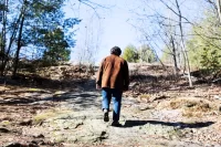 Brett Karpf ’26, of New York City, walks up Mount David at Bates College on March 18, 2026. (Theophil Syslo | Bates College)