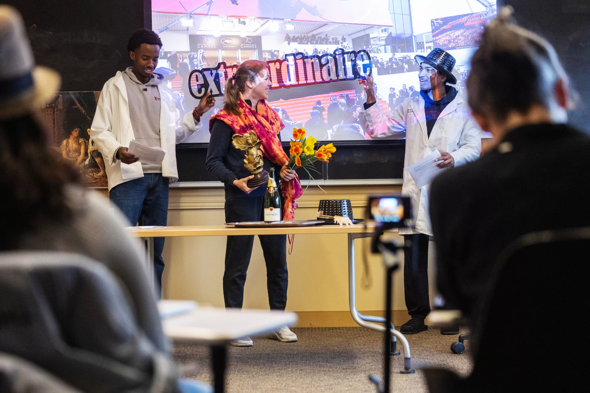 Moments from inside Laura Balladur's course FR205 in Roger WIlliams Hall captured on March 16th, 2026. Monday's are a performance day and often include theater-based games and improv.(Theophil Syslo | Bates College)
Laura Balladur is Lecturer in the French and Francophone Studies department at Bates College since 2003. Her broad interests include translation both in theory and practice, cinema, the relationship between literature and science, and the embodied mind. Her dissertation “Imagination, Physiology, and the Dynamics of Representation” (2005) explored the emergence of proto-biology in various 17th and 18th-century scientific texts in Europe. She has published on translation as well as on the history of science. Her latest article offered an alternate reading to Descartes’s dualism. True to her other undergraduate degree in Studio Arts, she keeps returning to her interest in creative projects. Currently, she is working on a creative non-fiction project describing our relationship with the Democratic Republic of the Congo, both past and present. With a generous Faculty Development Grant (April 2022), she traveled to the colonial archives in Brussels, followed by a trip to the Democratic Republic of Congo, in the North and South Kivu capitals: Goma, in the foothills of Mt Nyiragongo, and Bukavu, at the southern tip of Lake Kivu. She wanted to follow the imprints of colonial-era infrastructures onto the present-day territory. The collected voices from the many guides she met reveal the lasting wounds of colonialism with its persisting extractive economies that form the bedrock of our modern life. During the trip to the DRC, she taught a two-hour workshop on The Art of Creative Non-Fiction at the Université Catholique de Bukavu. In Fall 2022, students in her translation course met over Zoom with a few students from Bukavu who participated in that summer’s workshop. Her students’ translations along with the originals can be found here: Bridges to Bukav