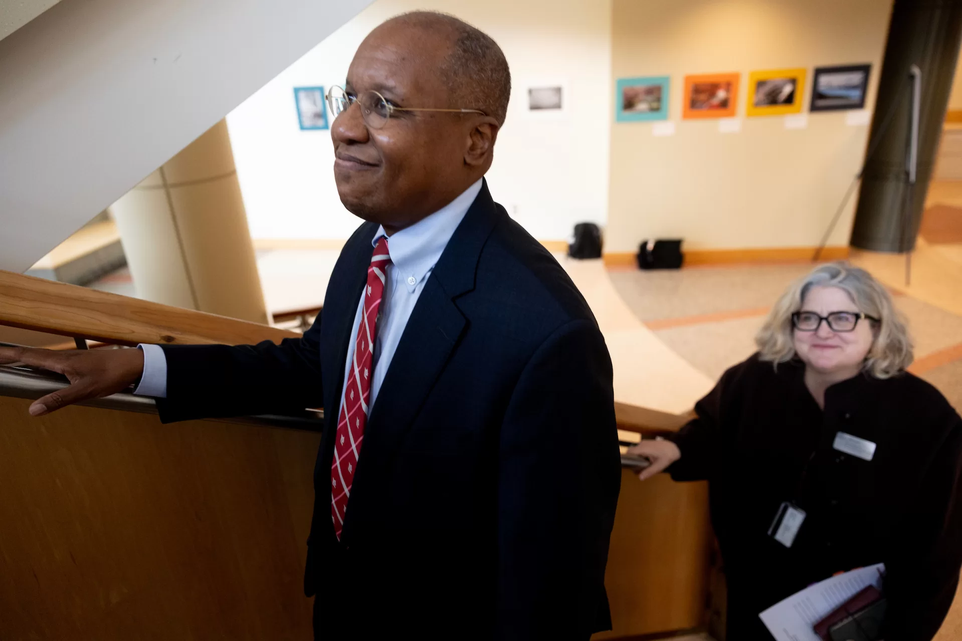 A man and a woman walking up a staircase.
