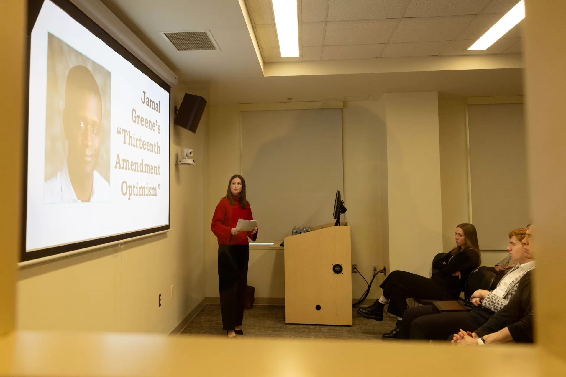 A women giving a presentation in a classroom.