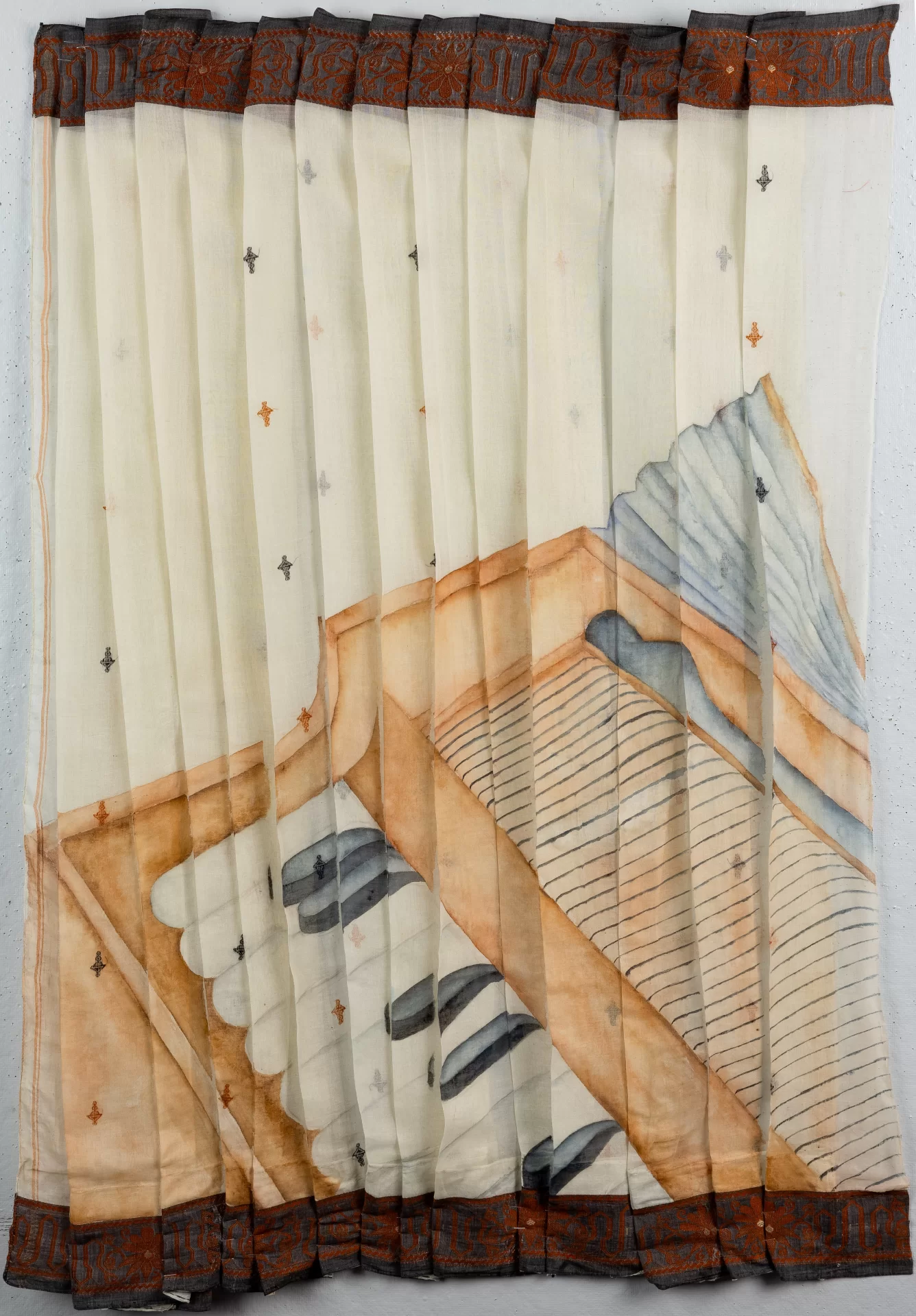 A painting of a harmonium on a white saree.