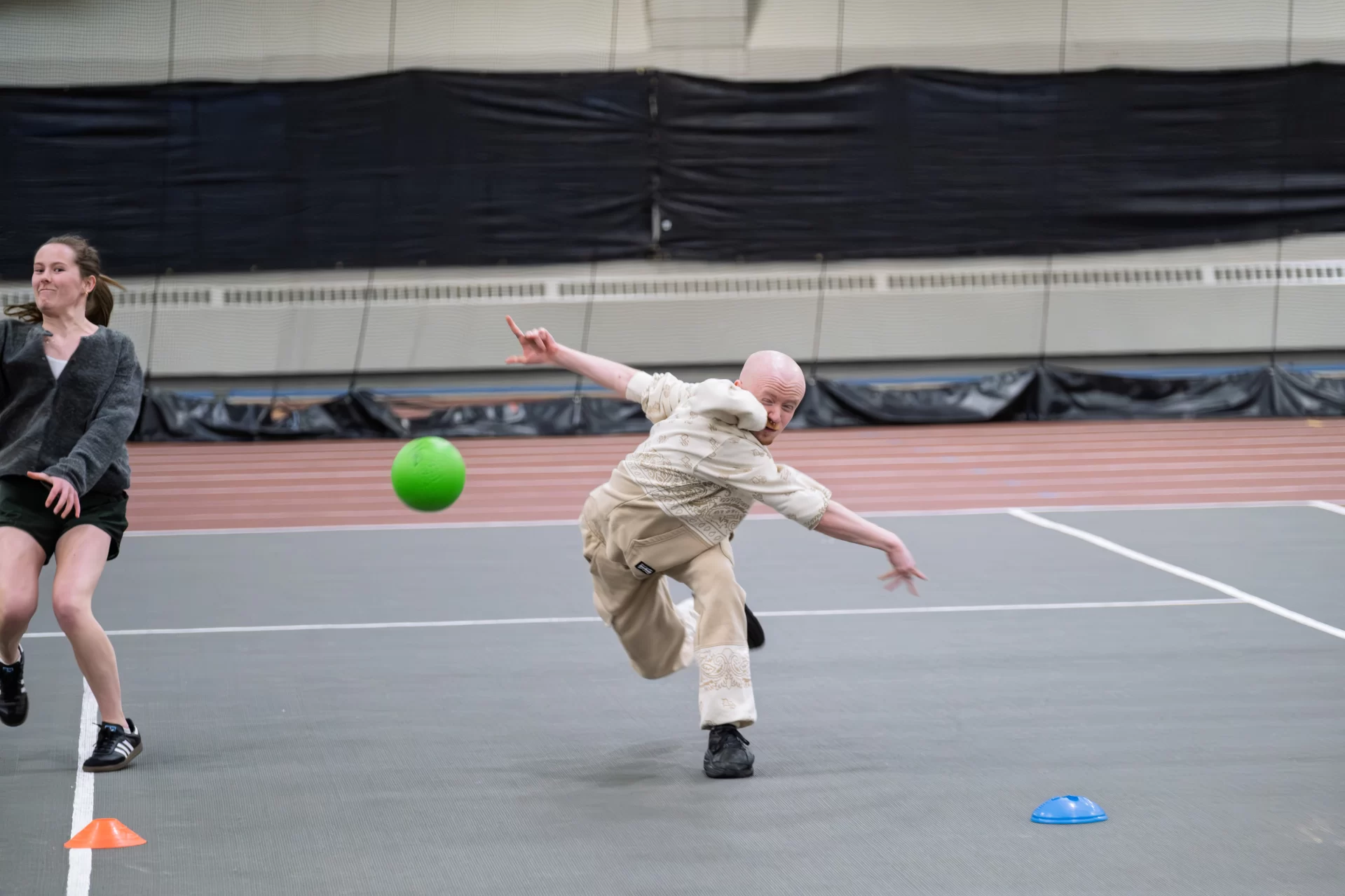 A student throws a ball during a dodgeball game.