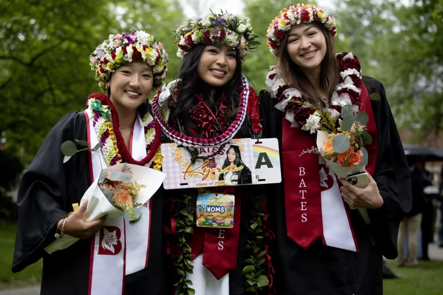 Three graduates from Hawaii pose for a post-Commencement portrait: Ellie Asada ’26 of Honolulu, Kyra Ong '26 of Kahului, and Ami Evans ’26 of Honolulu. (Phyllis Graber Jensen | Bates College)