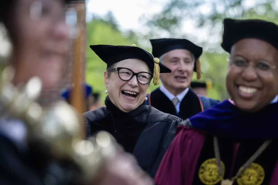 Author Deborah Harkness (center) prepares to process into the 2026 Commencement with President Garry W. Jenkins (Phyllis Graber Jensen | Bates College)