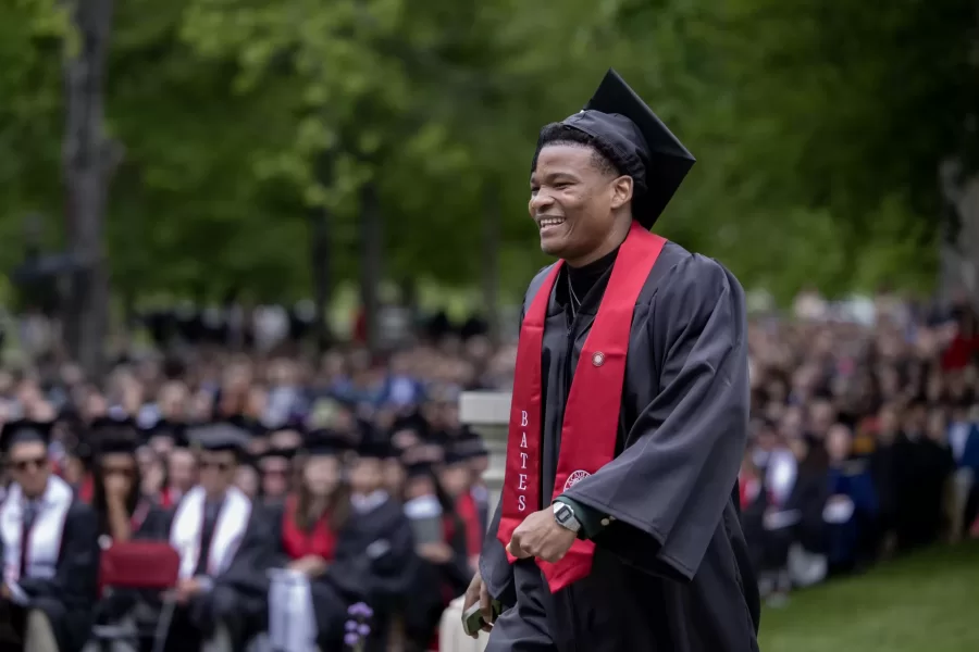 Senior speaker Sebenele Lukhele ’26 of Manzini, Eswatini on his way to the podium to deliver the senior speech. Lukhele spoke about what drew him to Bates, a place he enrolled in without visiting first. (Phyllis Graber Jensen | Bates College)