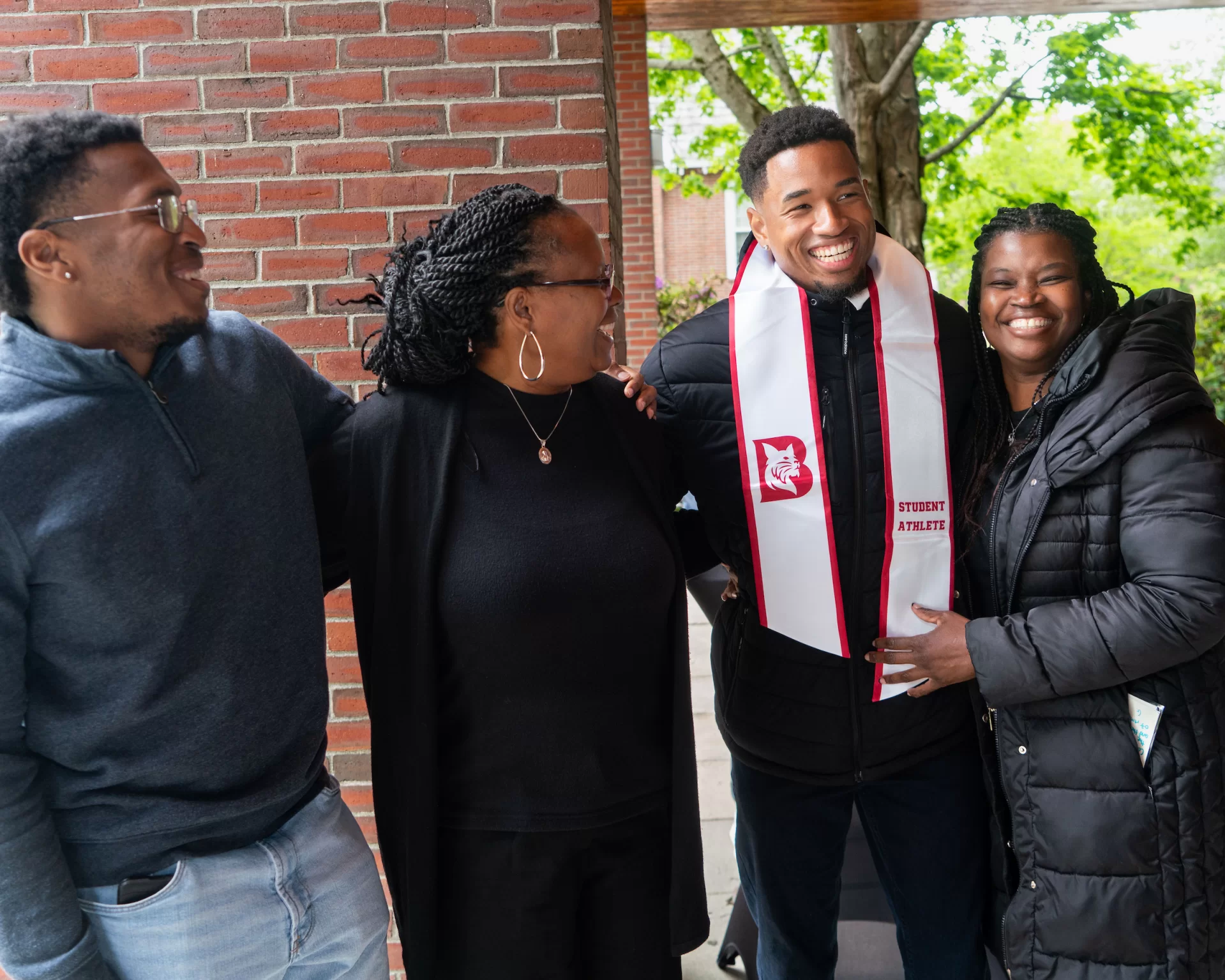 A group of people embracing and smiling