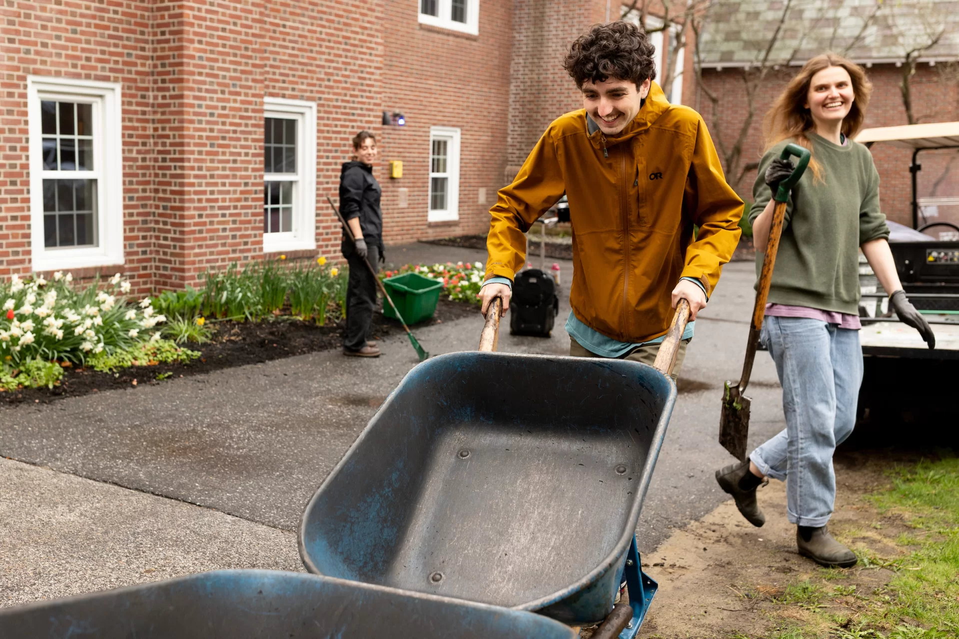 A man pushing a wheelbarrow outside