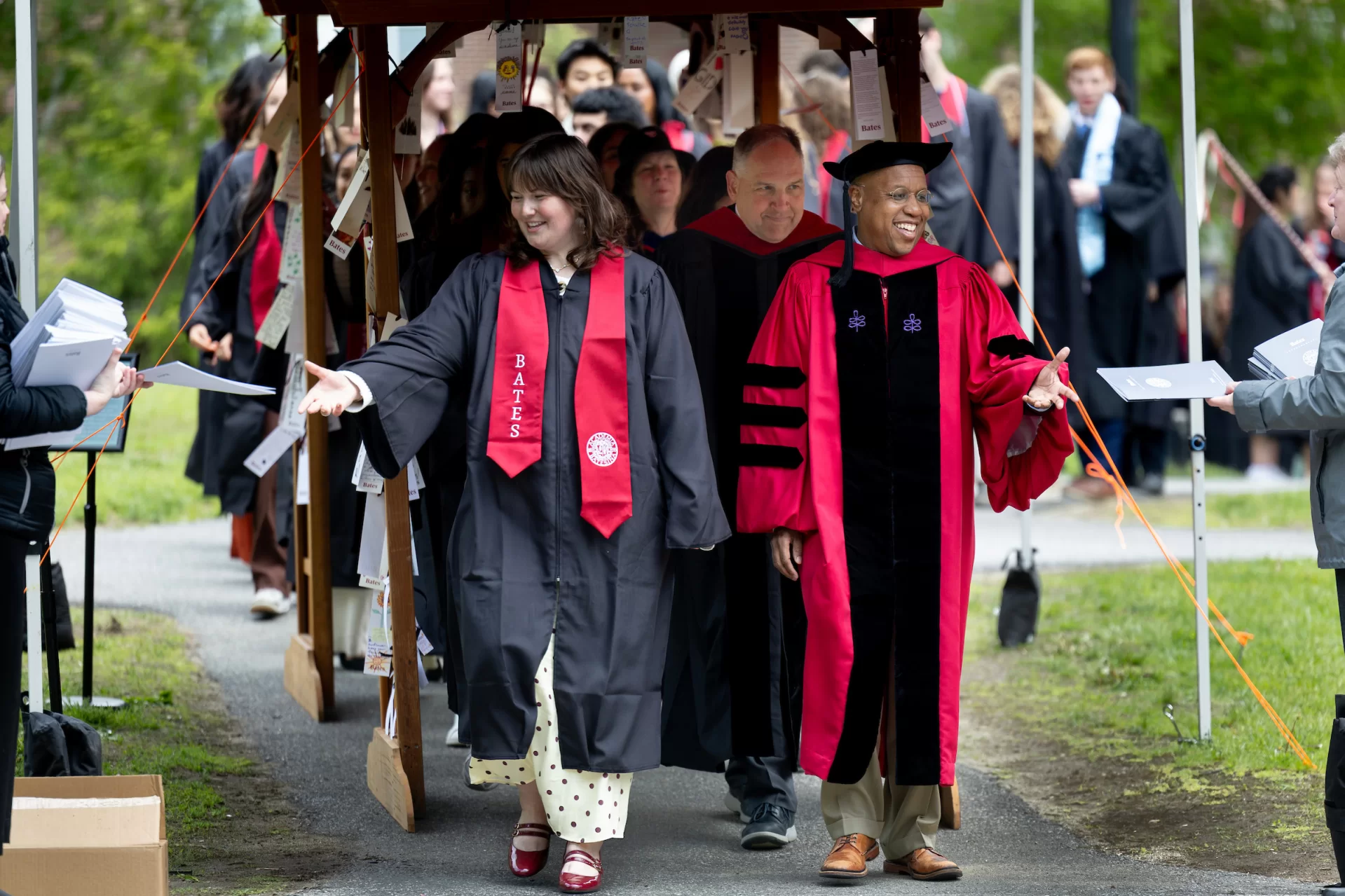 One Baccalaureate tradition is that the processional passes through archways adorned with prayers, poems, and blessings offered by parents, guardians, and other loved ones. Here the processional, led by President Garry W. Jenkins, makes its way through the Class of 2026 archway on May 30, 2026. (Phyllis Graber Jensen/Bates College) 