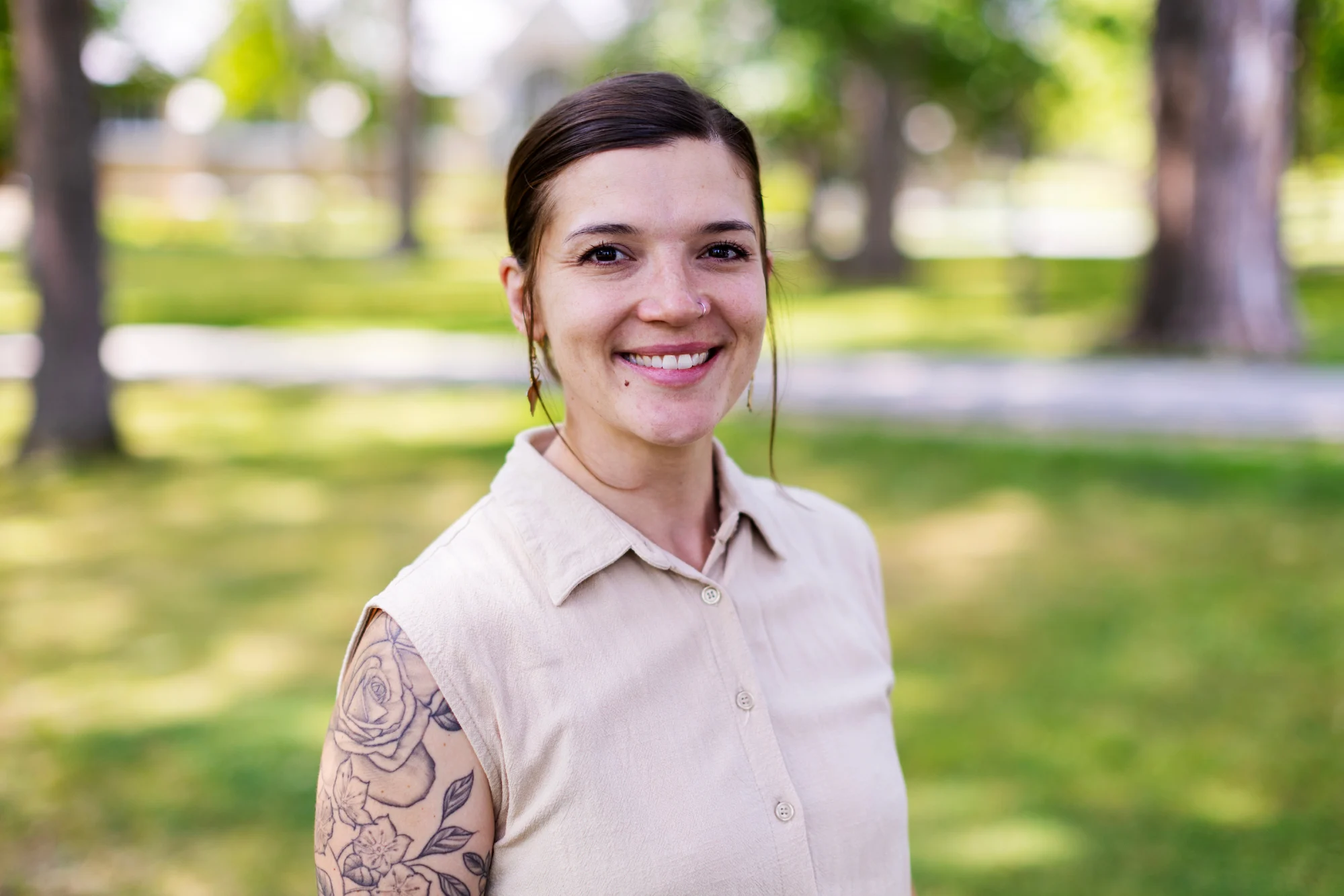 A woman smiles outside