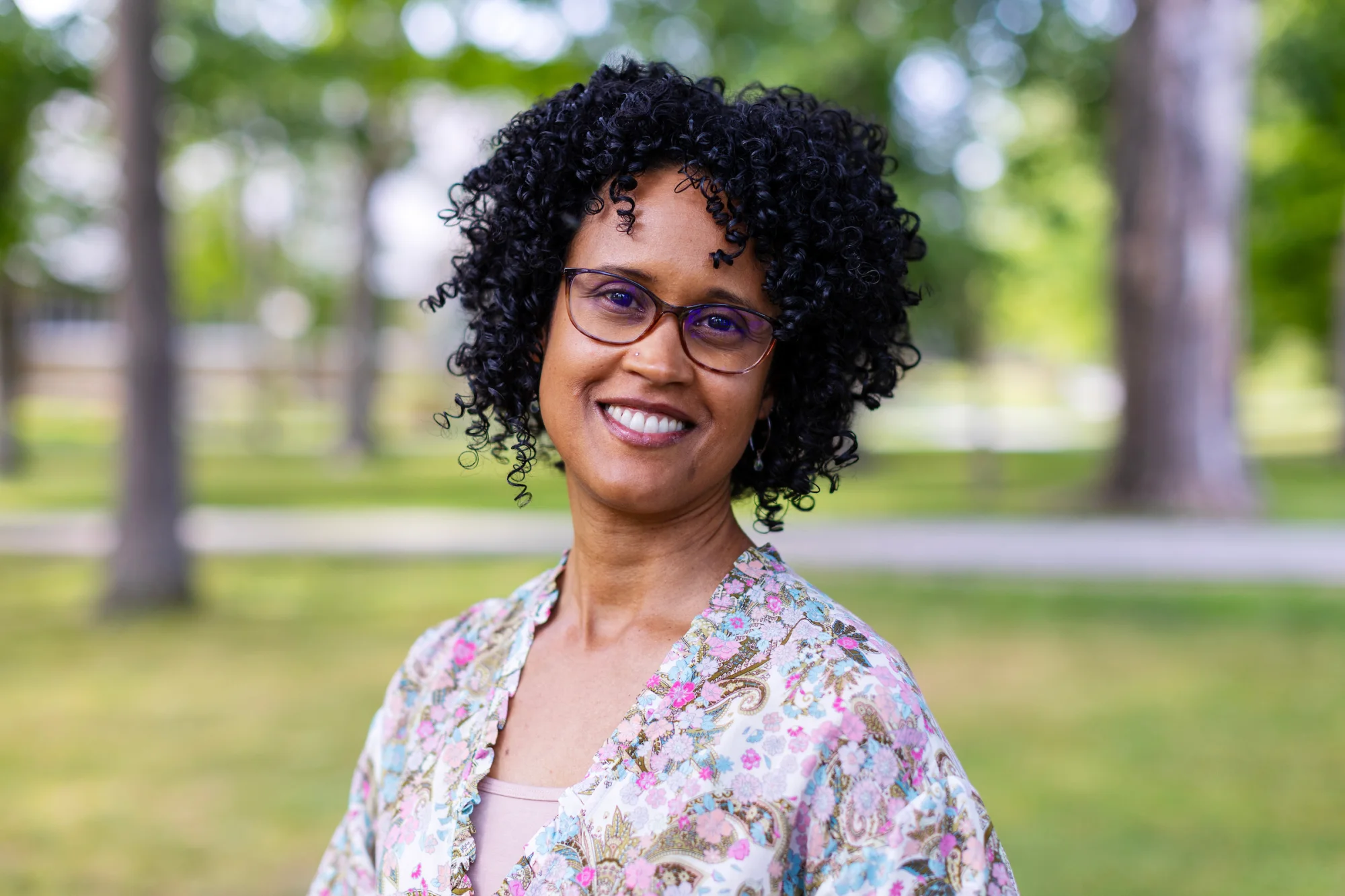 A woman smiles outside