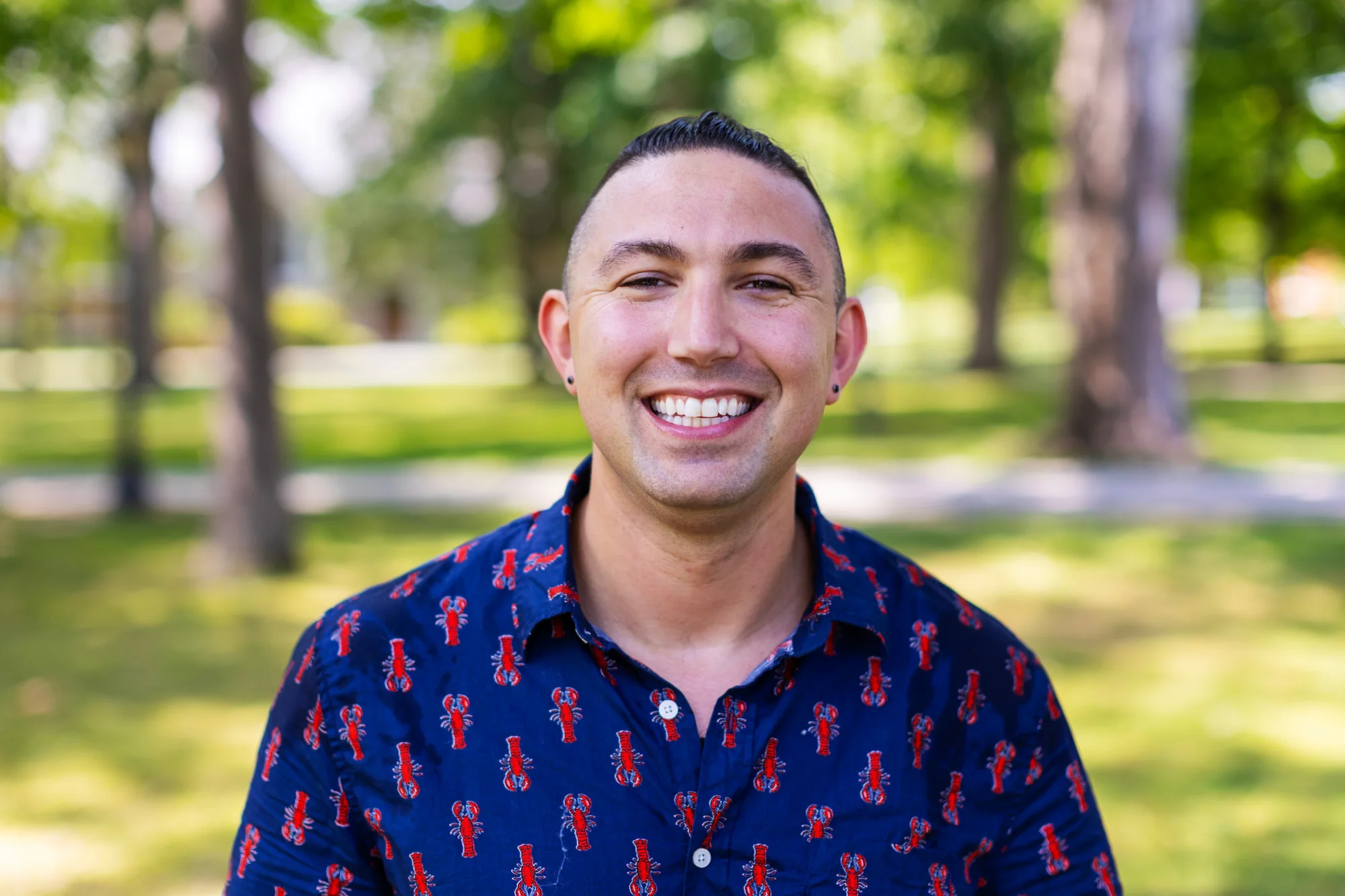A man smiles outside