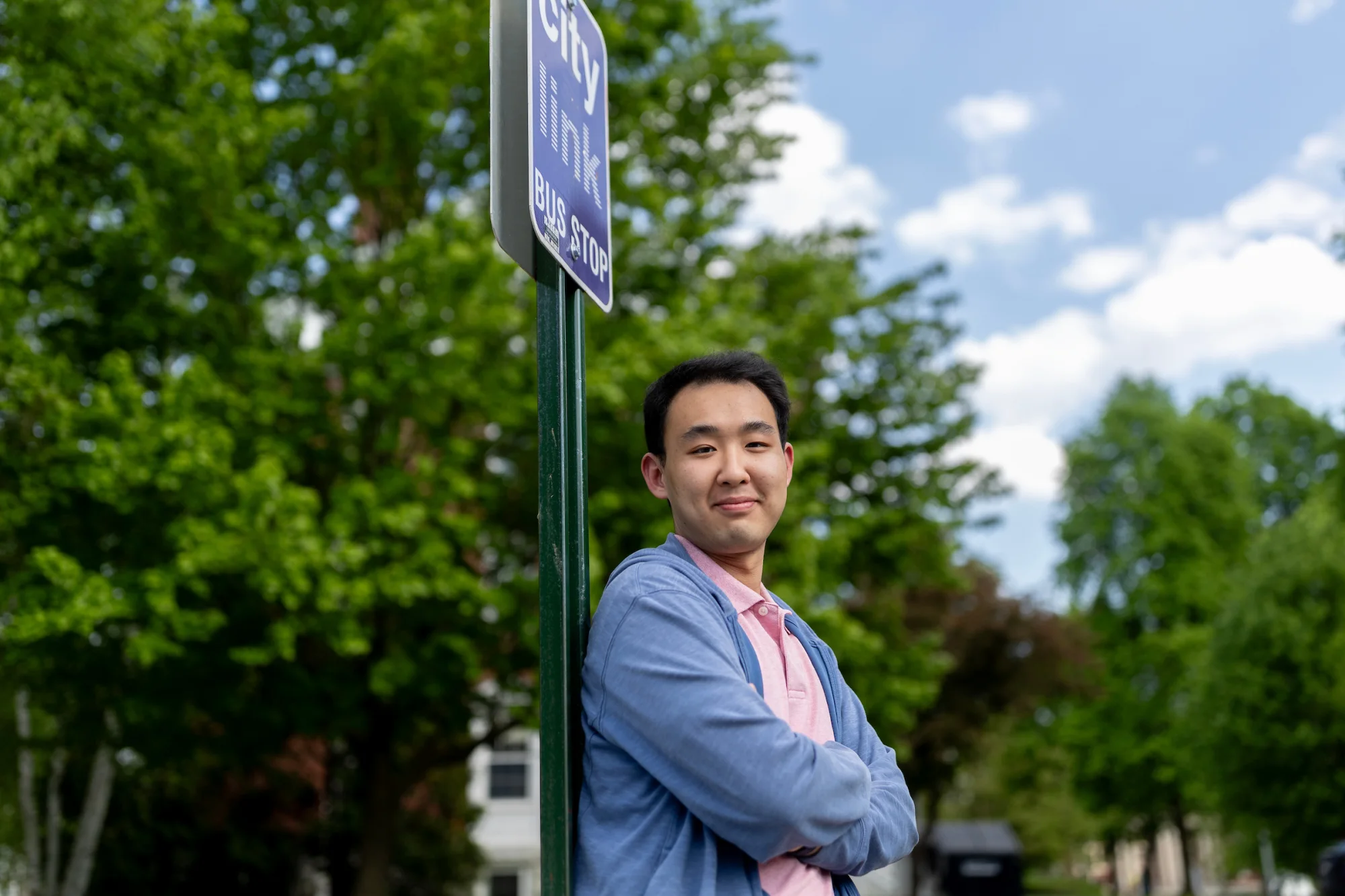 APPROVED, Alan Wang ’24 on College Street in front to Parker Hall where covered bus stop will be built on lawn behind him.
11/13/2023 16:25:54 Transportation for Bates awang3@bates.edu 5075817683 Student
Better Bus Stop for Bates
The MaineDOT is planning on implementing a commuter bus line between Lewiston and Portland. The bus line is set to terminate at Bates near Underhill Arena. However, the bus stop might not be pleasant and intuitive to use. Study from University of Minnesota show that bus stop amenities have a direct relationship with rider's perceived waiting time; having a bench can reduce the perceived waiting time by half compared to a stop without a bench. A well-equipped bus stop can entice more people to use it, thus reducing Bates' carbon footprint. "A bus shelter costs around $5,500. I want to apply for the full $2,000 grant to ultimately put this money back in the school's pocket, in the form of a well-designed bus shelter. This green fund can be a part of a larger funding package, I'm assuming that MaineDOT and the operator of this bus line will both pitch in to fund this shelter.
The bus shelter should protect riders from weather elements, display proper signage and maps, equip with lighting and seating. MaineDOT also recommends installing bike racks and trash cans. The green grant can be used to achieve aspect(s) of the above objectives. " Increase comfort level when using public transportation. Reduce perceived waiting time. Encourage faculties and staff to commute using public transportation, thus reducing GHG emissions and free up parking spots.
