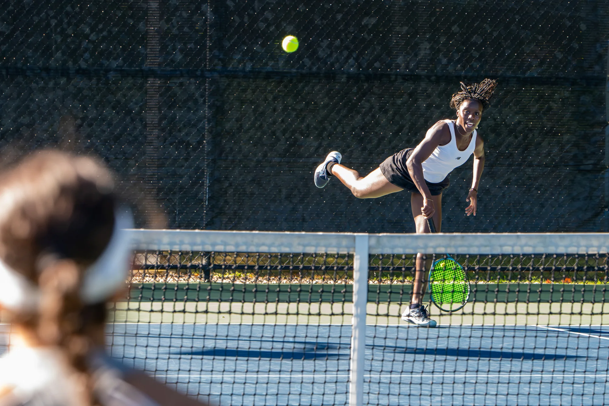 A tennis player serves a ball