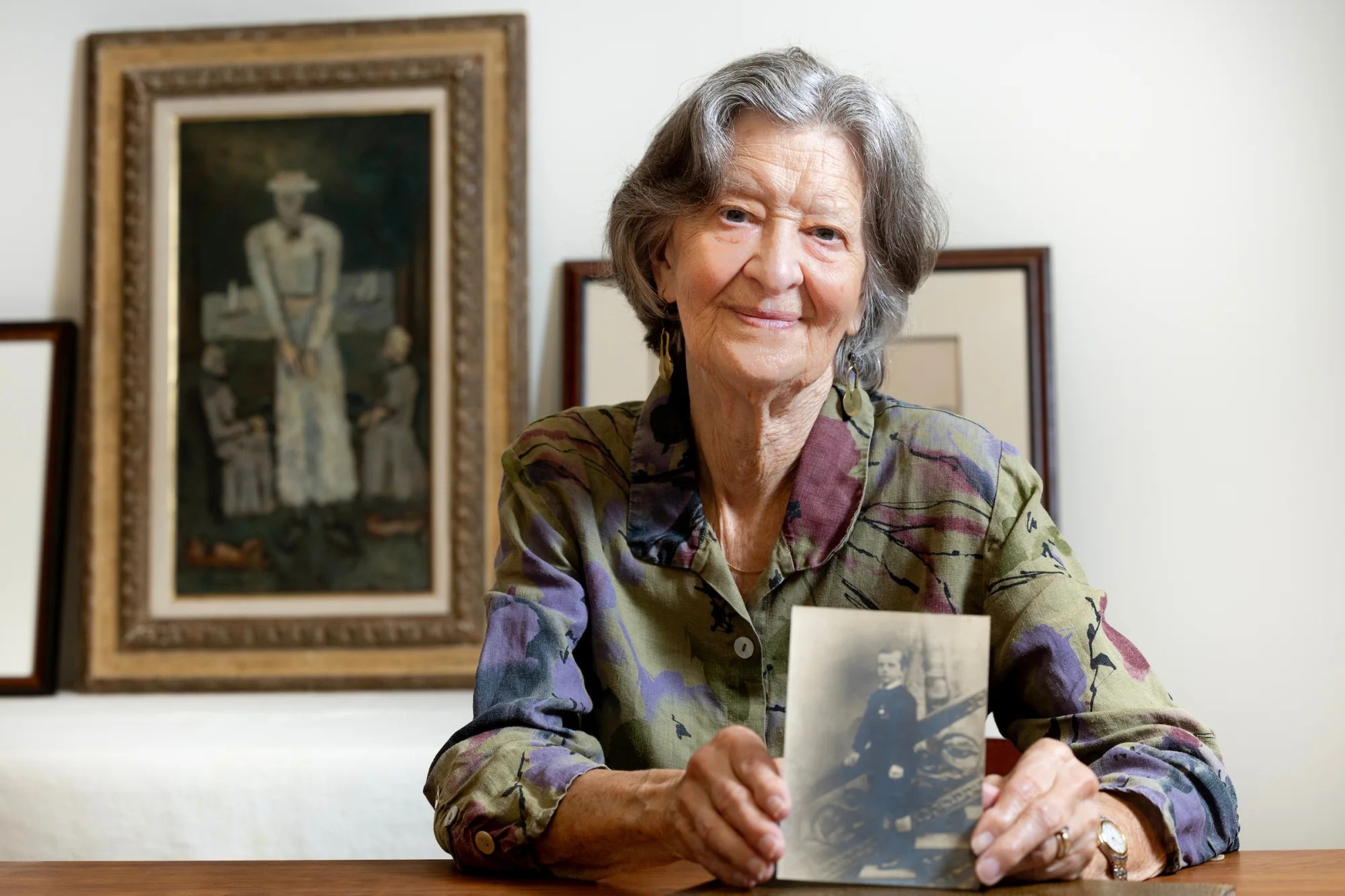 Independent art historian and long-time Marsden Hartley scholar, Gail R. Scott  is photographed on the lower level of the Bates College Museum of Art on Aug. 21, 2027, after an interview with Mary Pols for a Bates Magazine story.. Scott is photographed with a painting, “Intellectual Niece” and a photograph that shows  Hartley and a woman who is believed to be Norma Berger, an important figure in the Bates/Hartley connection.

Scott and the Bates College Museum of Art inaugurated the Marsden Hartley Legacy Project: The Complete Paintings and Works on Paper (MHLP). This comprehensive, annotated online catalogue of all known paintings and works on paper created by Hartley during his lifetime will establish a legacy befitting Marsden Hartley’s place in American art.