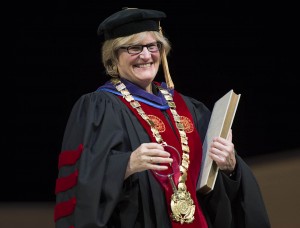 Clayton Spencer holds the symbols of office during her installation ceremony as the eighth president of Bates College. The symbols are the keys, the presidential collar and the record book.