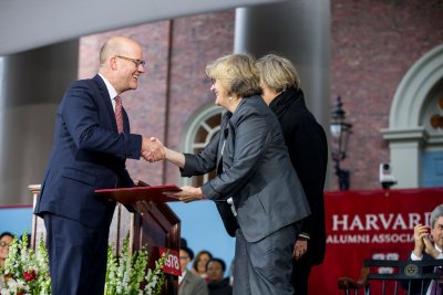 Phillip Lovejoy, executive director of the Harvard Alumni Association, presents Bates President Clayton Spencer with the association's Harvard Medal on May 25. Behind Spencer is Harvard president Drew Faust. The HAA's annual meeting took place in Tercentenary Theatre, Harvard, during the afternoon program of Harvard's Commencement. (Rose Lincoln/Harvard University)
