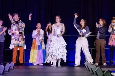 Bates people on stage in costumes made from recycled materials
