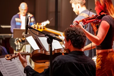 Students perform alongside a Radio Head tribute group in the Olin arts center during the weekend of october 25, 2025 both before and during the concert which Lewiston community members were invited to,