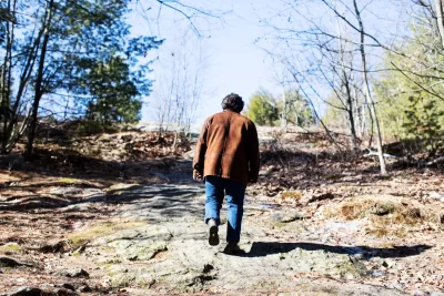 Brett Karpf ’26, of New York City, walks up Mount David at Bates College on March 18, 2026. (Theophil Syslo | Bates College)