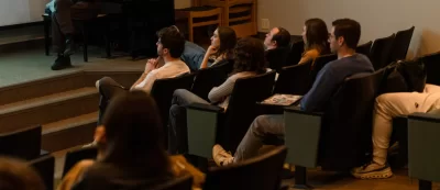 Lewiston, ME, United States  -- Guest lecturer Chris Schiff, the Music and Arts Librarian at Bates, watches the film “Say Cheese!” by Bates alum Amy Geller `96, during a Film Festival Studies taught by Professor Jonathan J. Cavallero in Olin Arts Center 105 at Bates College in Lewiston, ME on Wednesday, March 25, 2026. Schiff was there to talk about potential copyright issues with the music that is used in the film. Students discussed whether they should show the film at the upcoming festival. (Photo by Yoon S. Byun) © 2026 Strewn Wonder, LLC