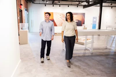 Tristan Seavey ’26 of Calais, Maine, and Rachel Ferrante ’10, Executive Director Maine MILL, pose for portraits at the new Maine MILL site on May 26, 2026. (Theophil Syslo | Bates College)