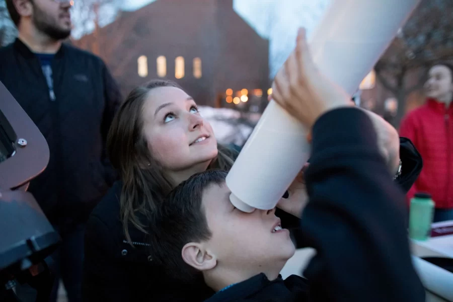 Children with telescope.