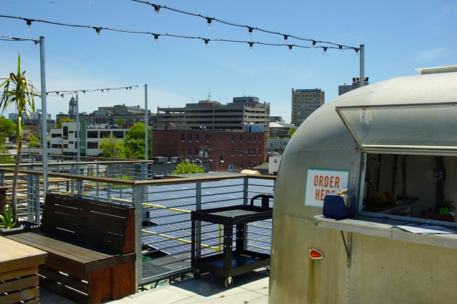 Rooftop taco truck and solar panels at the Bayside Bowl, with Portland's downtown in the distance. (Photo: Michael Sargent)