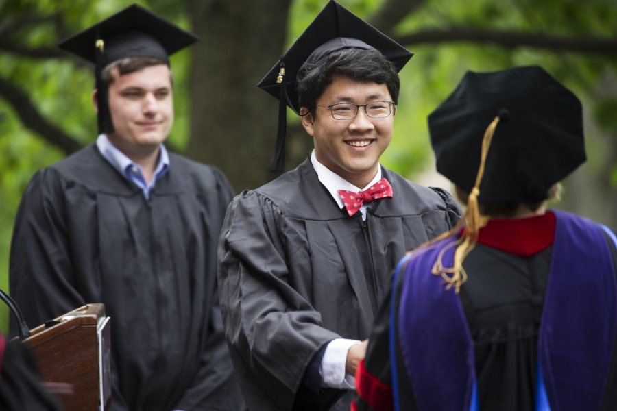 Elliot Chun, of Bedford N.H., receives his diploma while celebrating Bates 152nd Commencement on May 27, 2018.