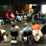 Group of people in a circle of chairs