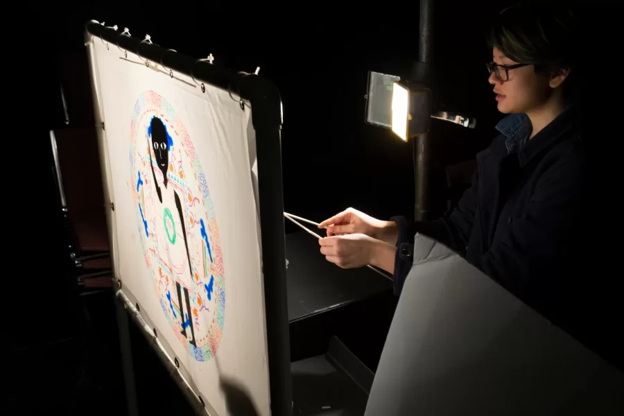 Keila Ching '18 of Honolulu, Hawaii, a student in "Epics of Asia" taught by Assistant Professor of Religious Studies Alison Melnick, performs their final project in the Black Box Theater. For their finals, the students were asked to reinterpret an epic myth in a format of their choice, and Ching opted to create a shadow puppet performance featuring a prologue to the Tibetan myth of Gesar of Ling