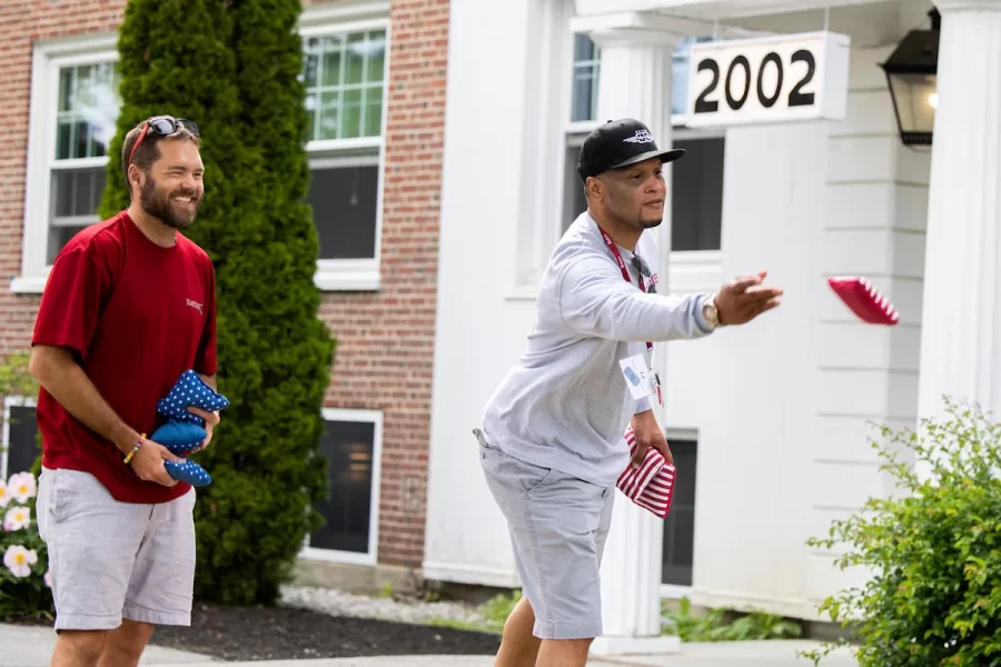 
Ed Walker ’02 and friends play a game of bags own the lawn in front of Smith Hall.