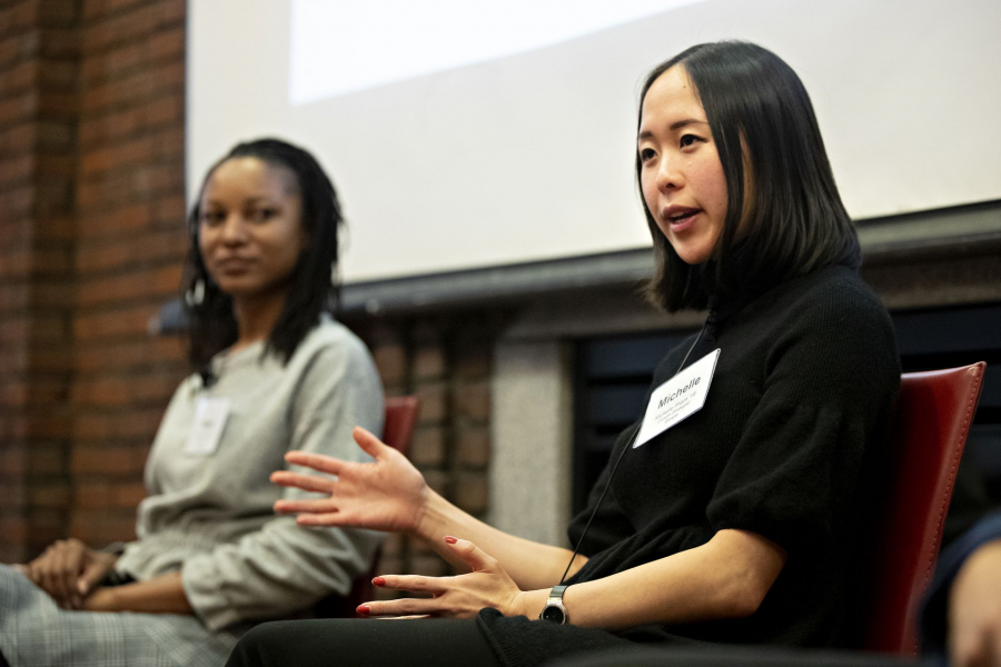 Two people speaking on a panel