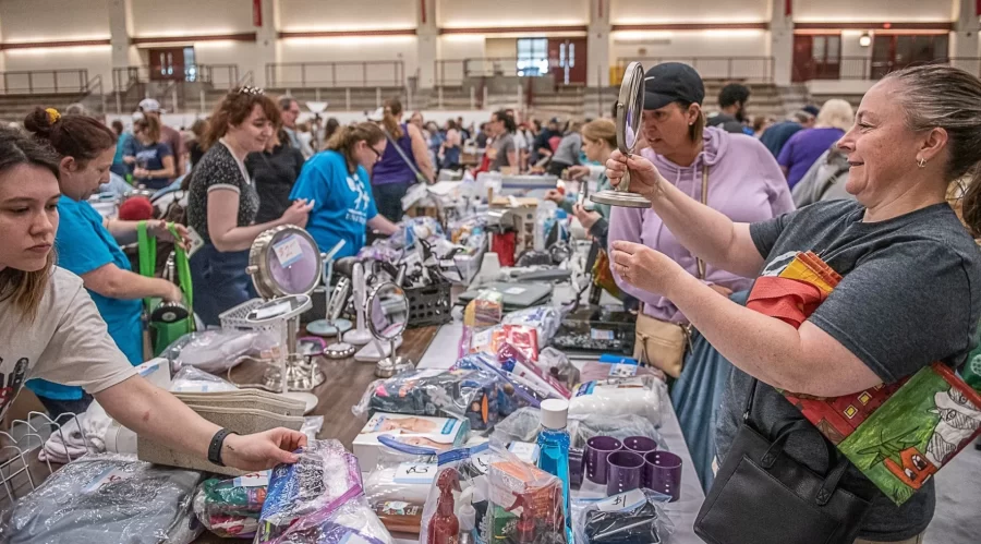 Bonnie Mosher, checks her reflection in a mirror at Clean Sweep. (Andree Kehn/Sun Journal)